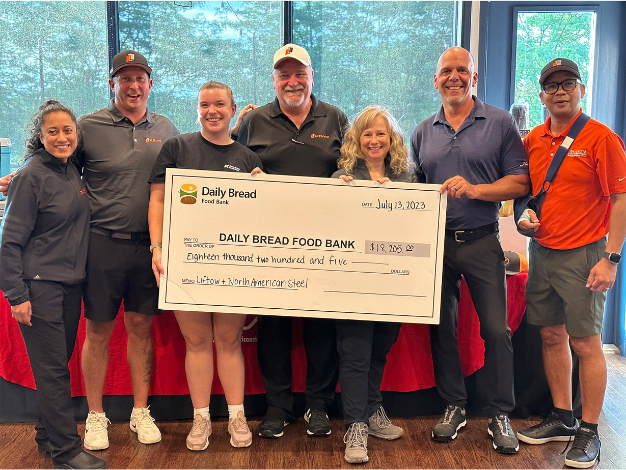 NAS, Liftow and Daily Bread representatives holding large cheque of $18,205 at charity golf tournament in support of Daily Bread Food Bank.