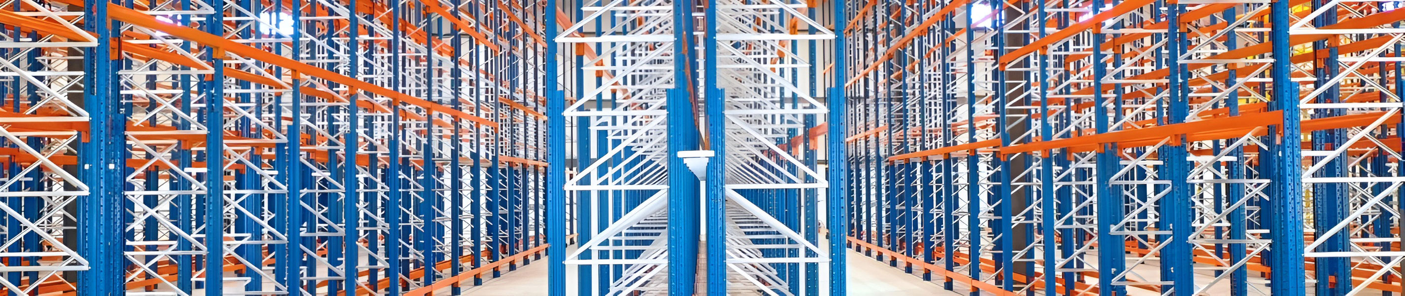 Frontal panoramic view of blue selective pallet rack frames fitted with orange step beams in an empty distribution facility.
