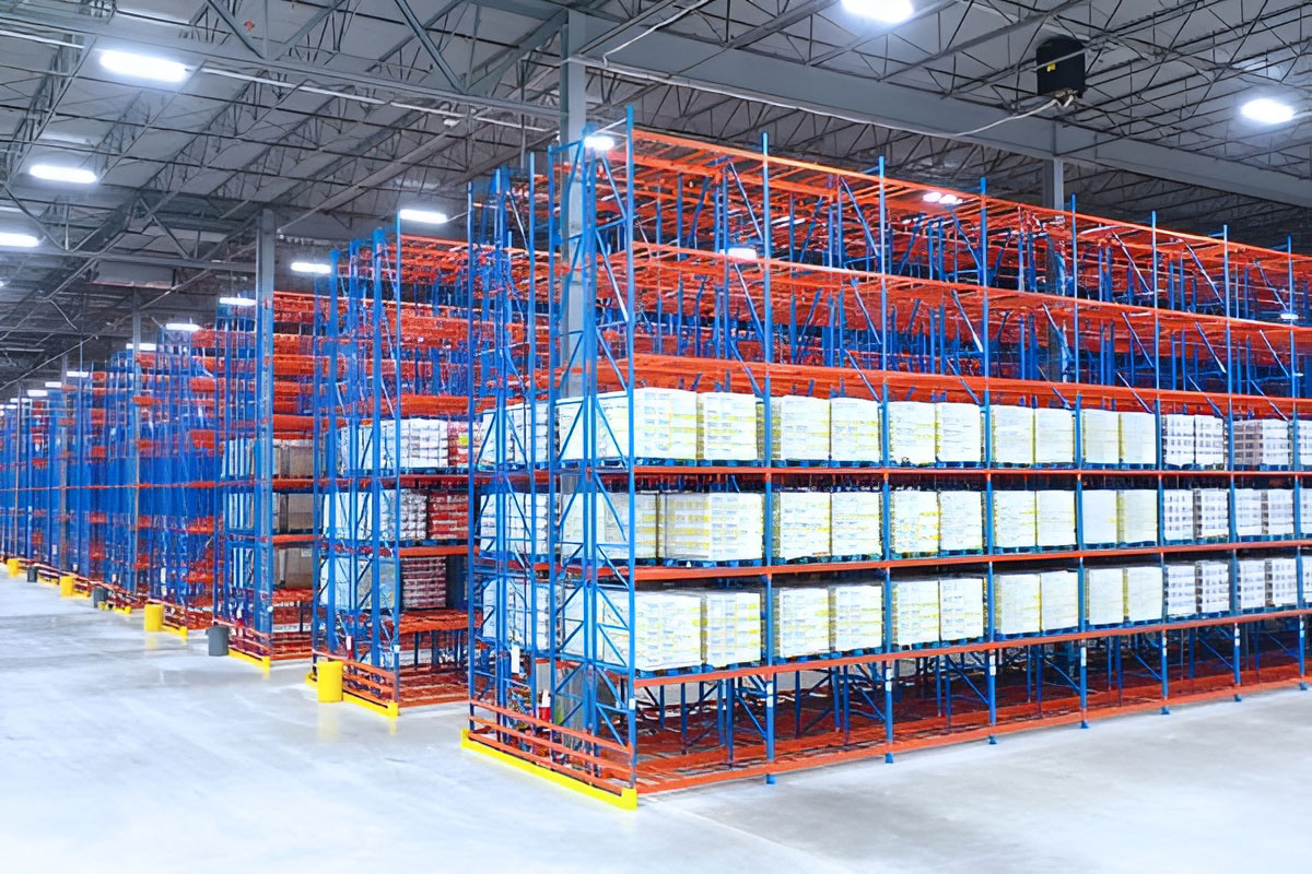 High-density double-deep selective pallet racking system stocked with uniform boxed inventory along deep warehouse aisles.