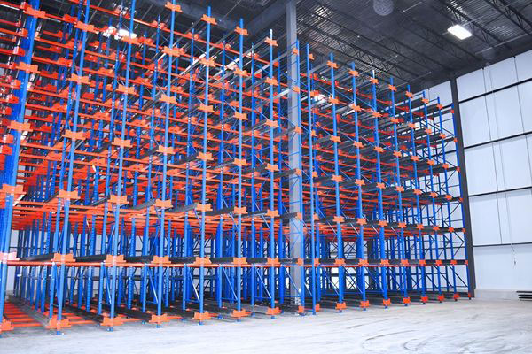Wide view of a large semi-automated shuttle racking structure built with blue uprights and orange guide rails.